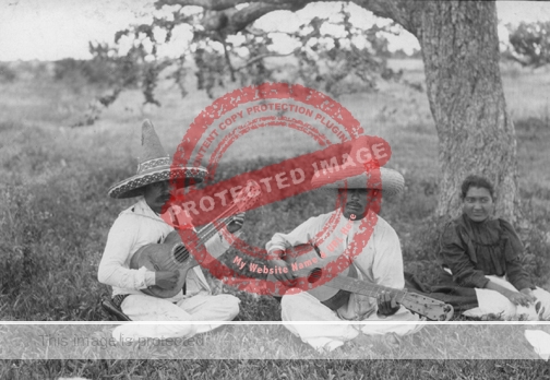 Sumner W Matheson. 1907. Tramp musicians who carry copper coins in sombrero and silver coins in their ears (note 25 cent in ear nearest tree) taken near Hotel Ribera, Lake Chapala. Reproduced courtesy of Milwaukee Public Museum, Wisconsin.