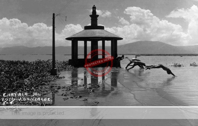 Jesús González. c 1967. Iconic photo of swimmers on pier. (Fig 8.19 of Lake Chapala: a postcard history)